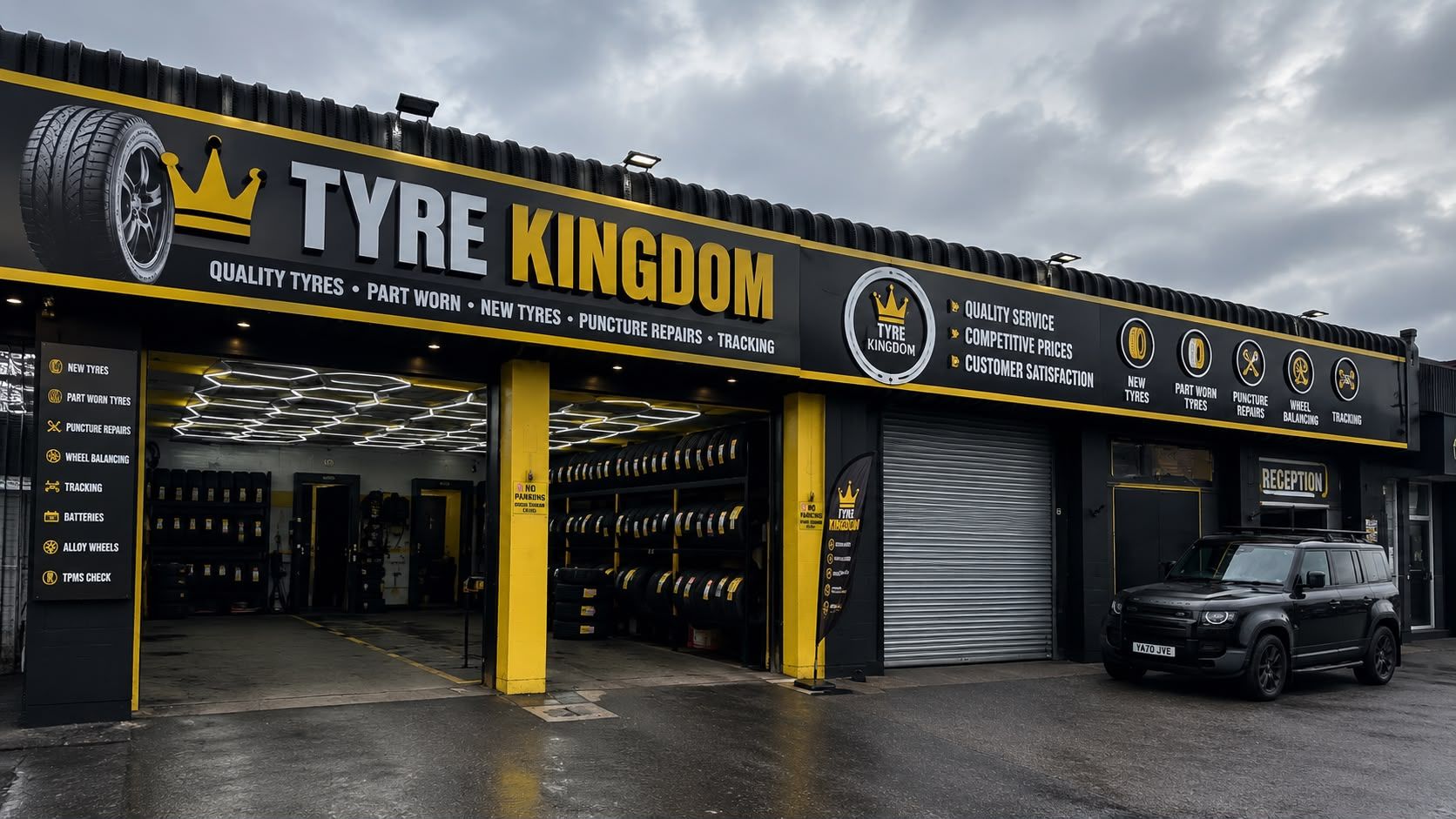 The Tyre Kingdom shopfront on Holdenhurst Road, with open bays full of tyres under the black and yellow sign
